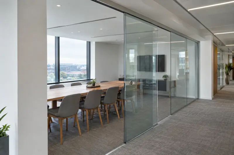 Sliding glass door on an overhead track. Frameless sliding glass door on an overhead track (illustrative)