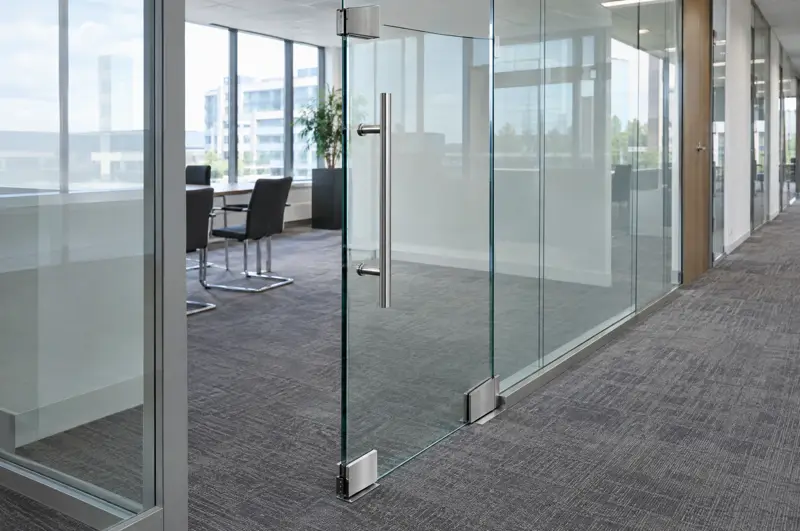 Frameless door on patch fittings. Frameless toughened glass door on patch fittings with a long pull handle (illustrative)